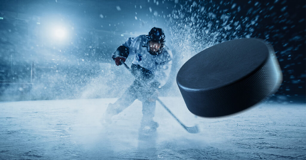IIHF WJC hockey player and hockey puck